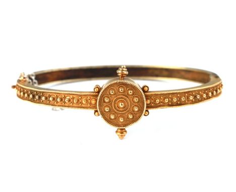 A Victorian yellow metal Etruscan Revival hinged bangle (probably 15ct), 14.8g.
