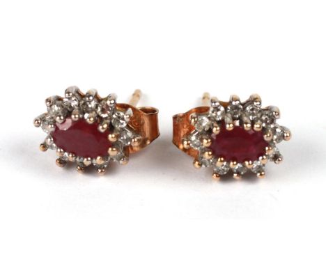 A pair of 9ct gold ruby and diamond cluster stud earrings.