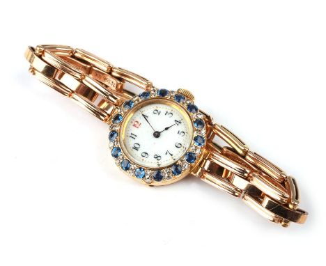 An Edwardian 18ct gold cased diamond and Ceylon sapphire set ladies wristwatch on a 9ct gold expanding strap, in a Goldsmiths