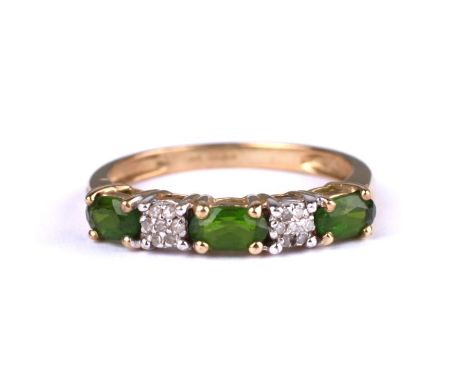 A 9ct gold dress ring set with three green stones interspersed with diamonds, approx UK size 'M', 1.6g.