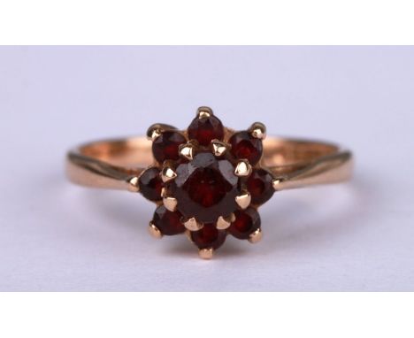 A 9ct gold garnet cluster ring, approx UK size 'L', 1.8g.