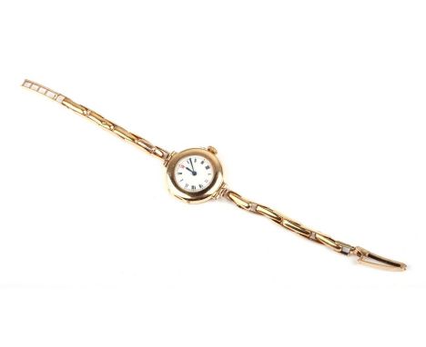 A ladies 15ct gold wristwatch on a 9ct gold strap with later quartz movement, total weight 16.2g.