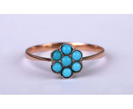 A 9ct rose gold flower head cluster ring set with seven turquoise cabochons, approx UK size 'L', 0.8g.