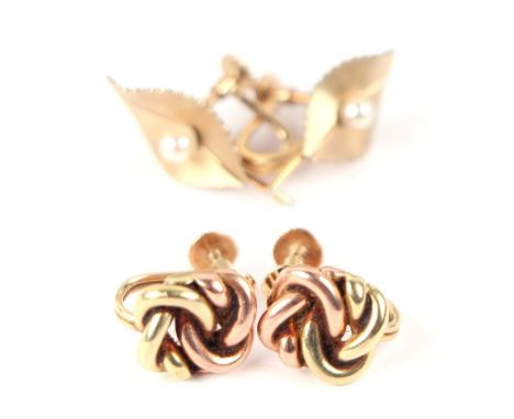 A pair of 14ct gold screw back knot earrings, 9.9g; together with a pair of yellow metal Krementz pearl set leaf form screw b