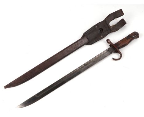 A WWI Japanese Arisaka bayonet with original leather fob, with five notches on the hilt, in a leather scabbard, 53cms long.