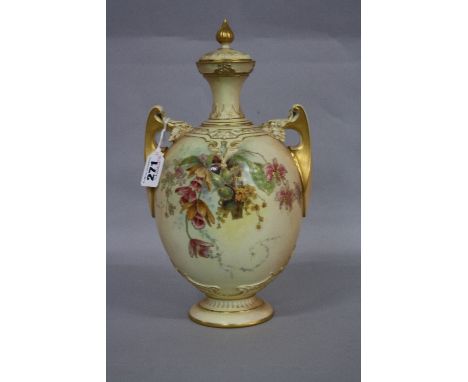 A ROYAL WORCESTER BLUSH IVORY TWIN HANDLED COVERED VASE, florally decorated with gilt detail, on pedestal foot, shape No.1684