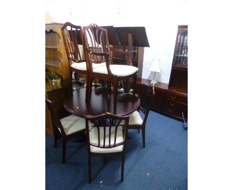 A MODERN MAHOGANY CIRCULAR EXTENDING DINING TABLE, and six chairs including two carvers, a similar three section wall cabinet