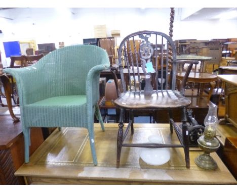 A WINDSOR STYLE WHEEL BACK KITCHEN CHAIR, a Lloyd Loom chair, an oil lamp with shade and funnel and part of a sewing machine 