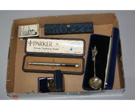 A CASED PARKER ARROW STAINLESS STEEL ROLLER BALL, Waterman roller ball, propaganda matchbox holder, RAF badges and a sterling