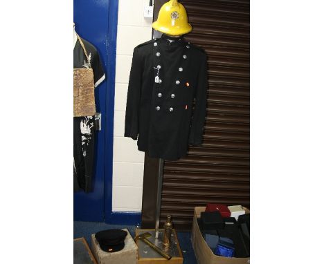 A WARWICK COUNTY FIREMAN'S JACKET, a West Midlands Fire Service helmet, a boxed Bates Service cap, a brass fire hose nozzle a