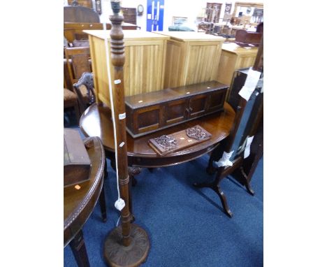 AN OAK STANDARD LAMP, a small oak cupboard and a hardwood book slide (3)