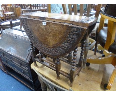 A SMALL CARVED OAK GATE-LEG TABLE, with bobbin turned supports