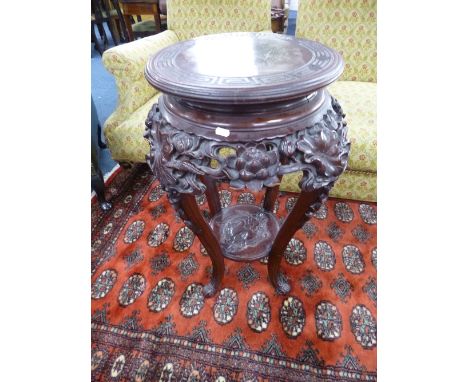 A CHINESE CARVED HARDWOOD PLANT STAND, with under shelf, approximate size diameter of top 40cm x height 73cm (sd)