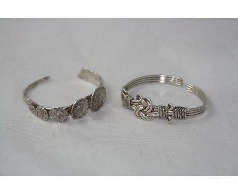 TWO SILVER CUFF BRACELETS, one of Celtic design, the other a circular hammered design (2)