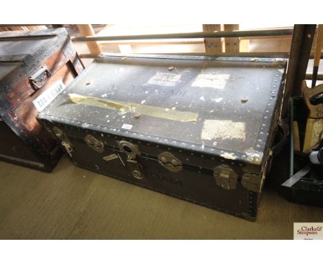 A wooden and metal bound travelling trunk with a quantity of duvets and material