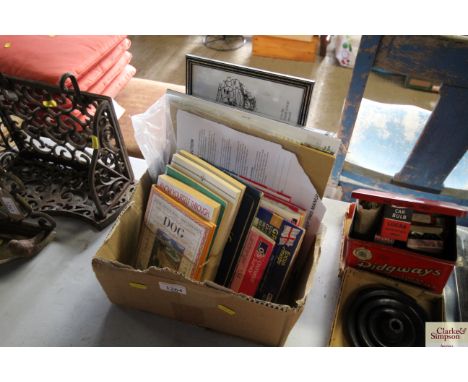 A cardboard box containing various maps; piano instruction book; humorous print etc.
