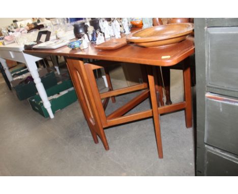 A teak gate leg dining table