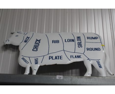 An enamel reproduction cow sign