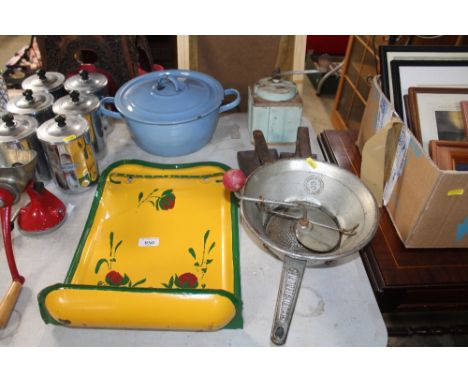 A Moulin-Legumes mincer together with six stainless steel storage jars; an enamel pot and cover and an enamel wall shelf