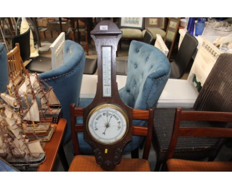 An oak cased barometer/thermometer