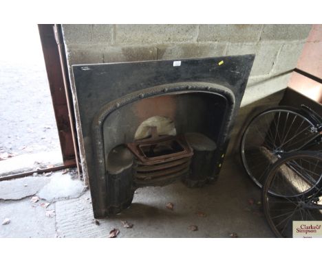 A cast iron fire place surround with internal fire grate