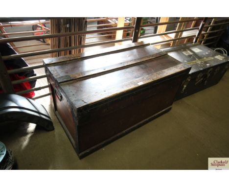 A wooden and metal bound travelling trunk with metal lining