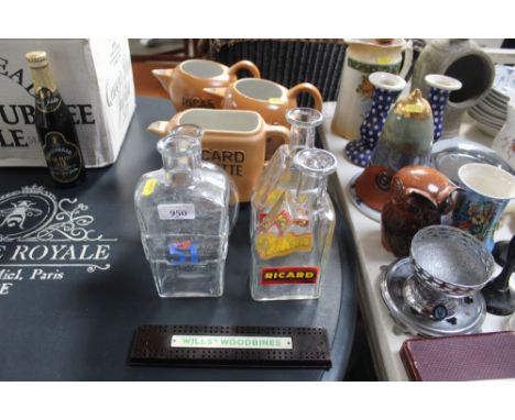 Three Rikard jugs; two Rikard glass jars; a flask; another flask; a Wills Woodbines cribbage board