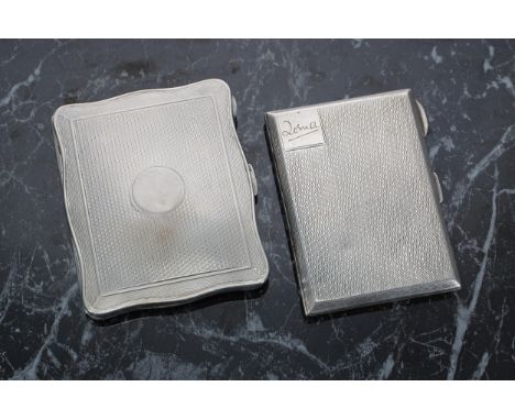 Two silver engine turned cigarette cases, the first of serpentine form with gilt interior, Birmingham 1923, 3.25" x 2.5"; the