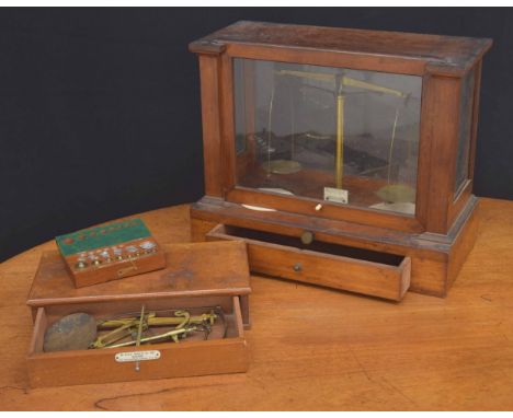 Set of Becker &amp; Sons balance scales, under a glazed case; also a box of weights and a small cased set of scales 