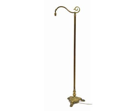 Art &amp; Crafts style brass standard reading lamp, on a trefoil base with cast paw feet, 65" high; with shade 