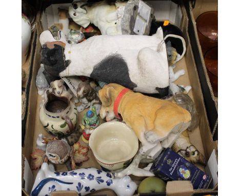 A box containing a collection of various ceramic and composition models of cats and dogs