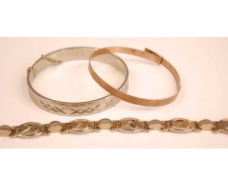 A 9ct gold engine turned bangle, 6.1g; together with a white metal hinged bangle; and a sectional bracelet (3)