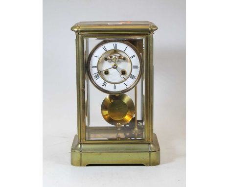 A late 19th century French brass four-glass mantel clock, the enamelled chapter ring showing Roman numerals and with visible 