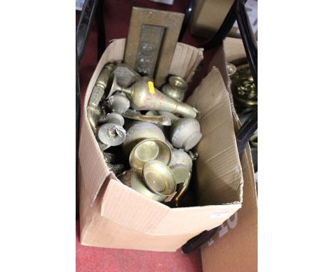 Two boxes containing a collection of various brassware etc to include a Victorian candlestick, eastern brass vase, etc