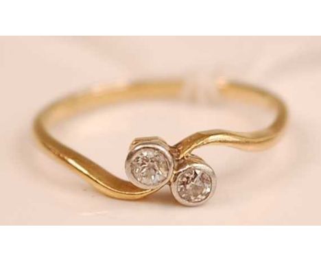 An 18ct gold diamond crossover ring, the illusion set round cuts each weighing approx 0.08ct, 2.2g, size R