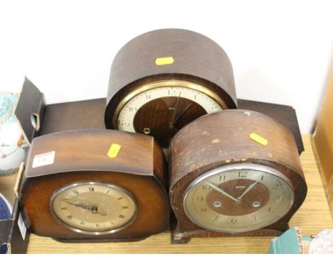 A 1950s Smiths oak cased mantel clock, having enamelled chapter ring with Arabic numerals and eight day movement; together wi