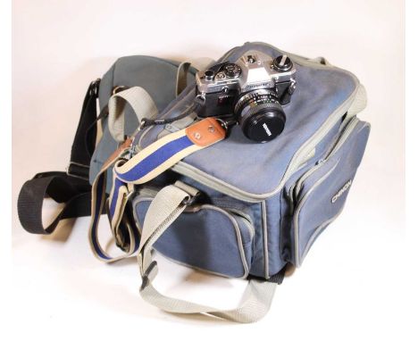 An Olympus OM10 camera with Miranda 28mm lens, in camera bag, with various accessories to include Miranda 75/200mm macro lens