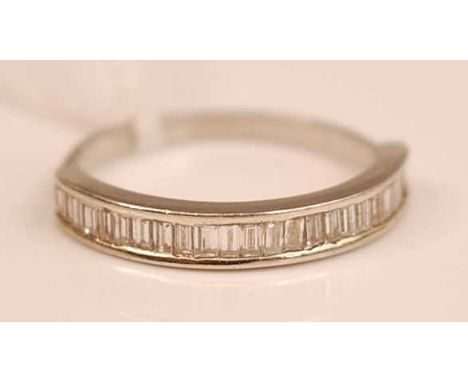 A platinum diamond set half eternity ring, channel set with 25 baguette cut diamonds, 3.5g, size P