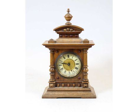 An early 20th century German walnut cased mantel clock, the enamel chapter ring showing Roman numerals, inscribed Made in Wur