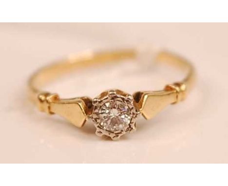 An 18ct gold diamond solitaire ring, the illusion set round cut diamond weighing approx 0.13 carats, 2.1g, size M