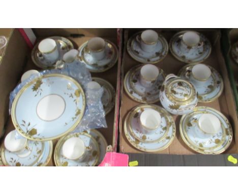 A 19th century part tea service, decorated in blue and gold, together with another 19th century tea set