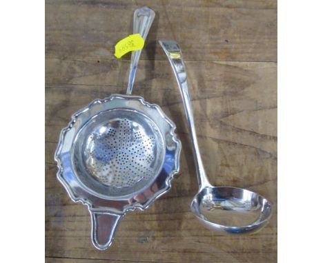 A Georgian silver sauce ladle, together with a silver tea strainer