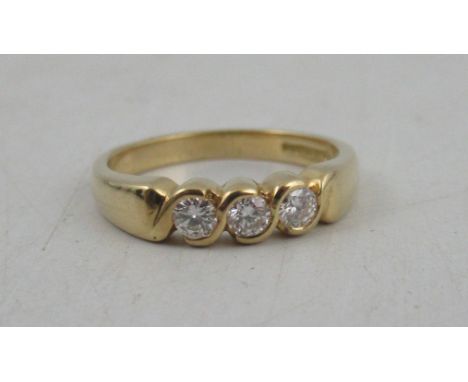 An 18ct gold three stone diamond ring, weight 4.5g, diamond approximately 0.09ct each, total weight 0.27ct, colour I/J, clari