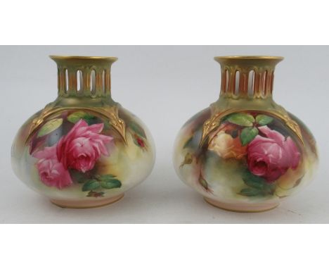 A pair of Royal Worcester vases, with pierced gilded necks, the body decorated with roses by Austin, shape number H306, heigh