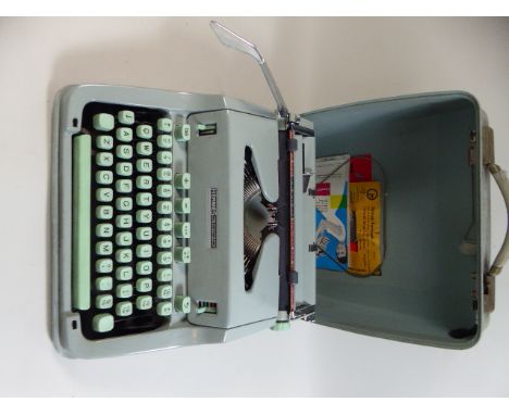 A Paillard of Switzerland Hermes 3000 Portable Typewriter in Metal Case 
