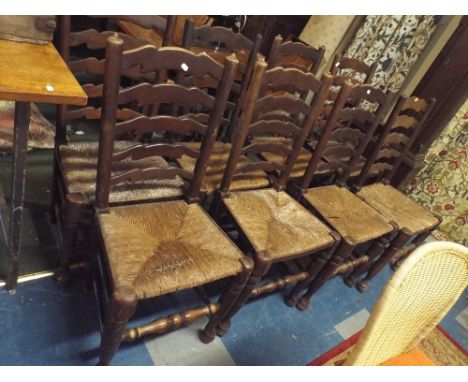 A Harlequin Set of Eight Ladder Back Rush Seated Dining Chairs