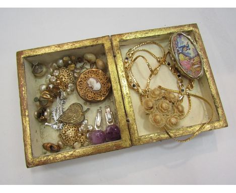 A small gilt trinket box with bijouterie contents including brooches, earring etc