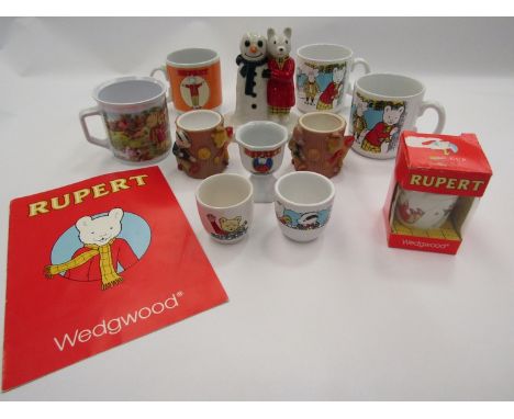 &nbsp;A selection of Rupert Bear ceramics and bag including a Wade figure, Wedgwood egg cup, mugs etc