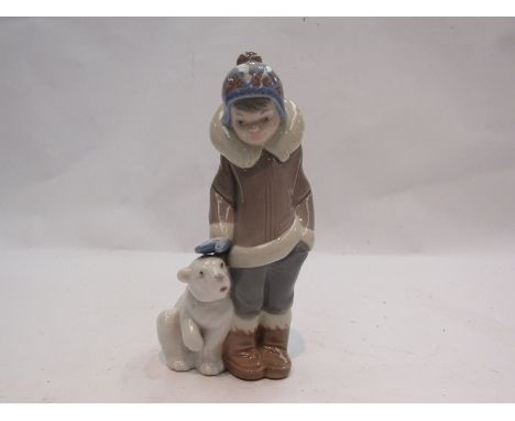 A Lladro Eskimo boy with Polar bear figure, model no. 5238, 15cm tall