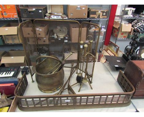 A quantity of brass fire tools including fender, scuttle and irons